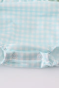 A blue smocked bubble with adorable bunny embroidery, perfect for spring outings.