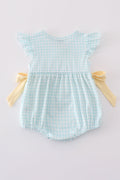 A blue smocked bubble with adorable bunny embroidery, perfect for spring outings.