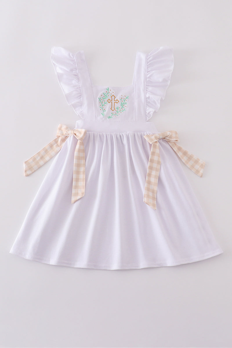 A pastel pink dress with Easter cross embroidery, perfect for spring celebrations.