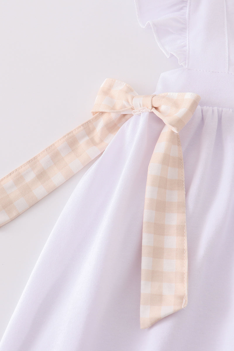 A pastel pink dress with Easter cross embroidery, perfect for spring celebrations.