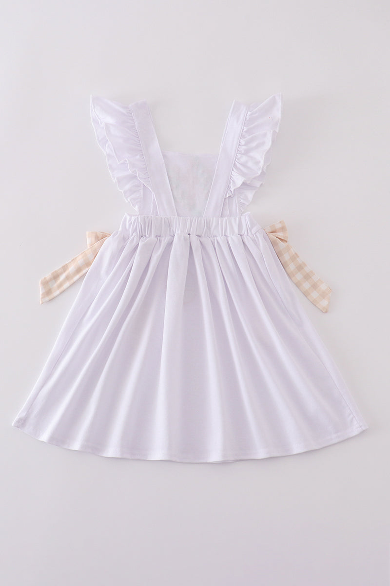 A pastel pink dress with Easter cross embroidery, perfect for spring celebrations.