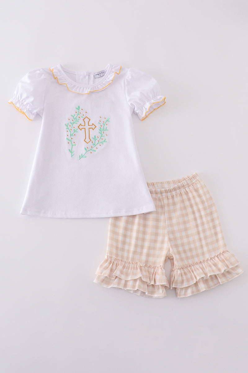Girls' Easter outfit with pastel cross embroidery and ruffled sleeves.