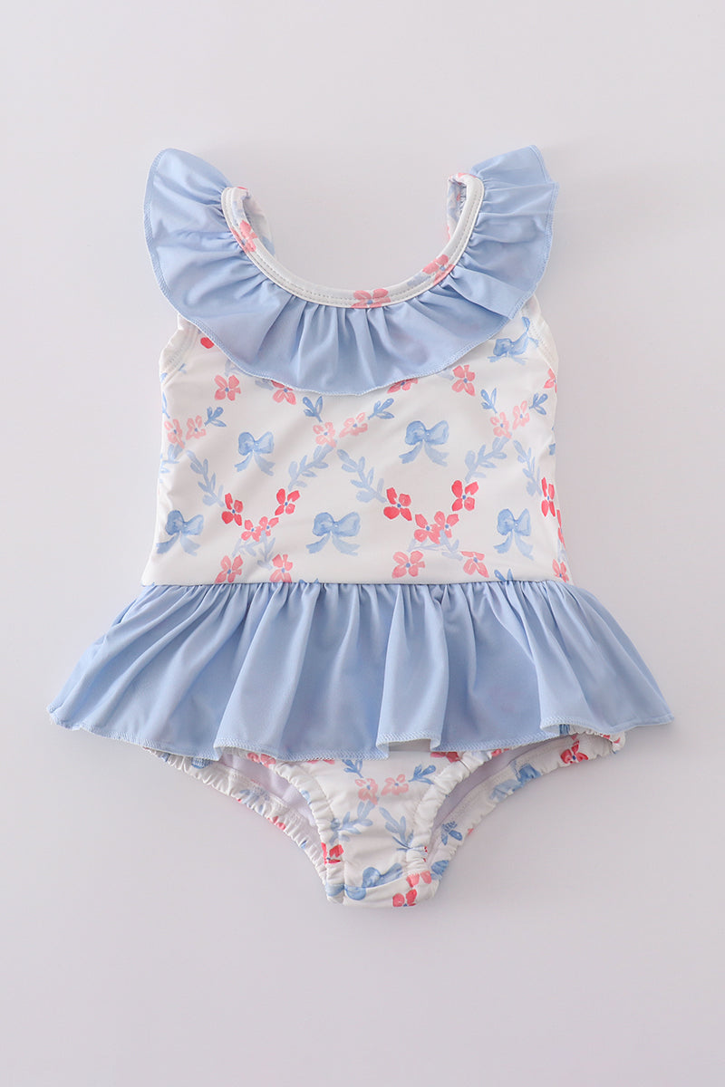 A charming blue lattice print swimsuit with a cute bow, perfect for summer fun.