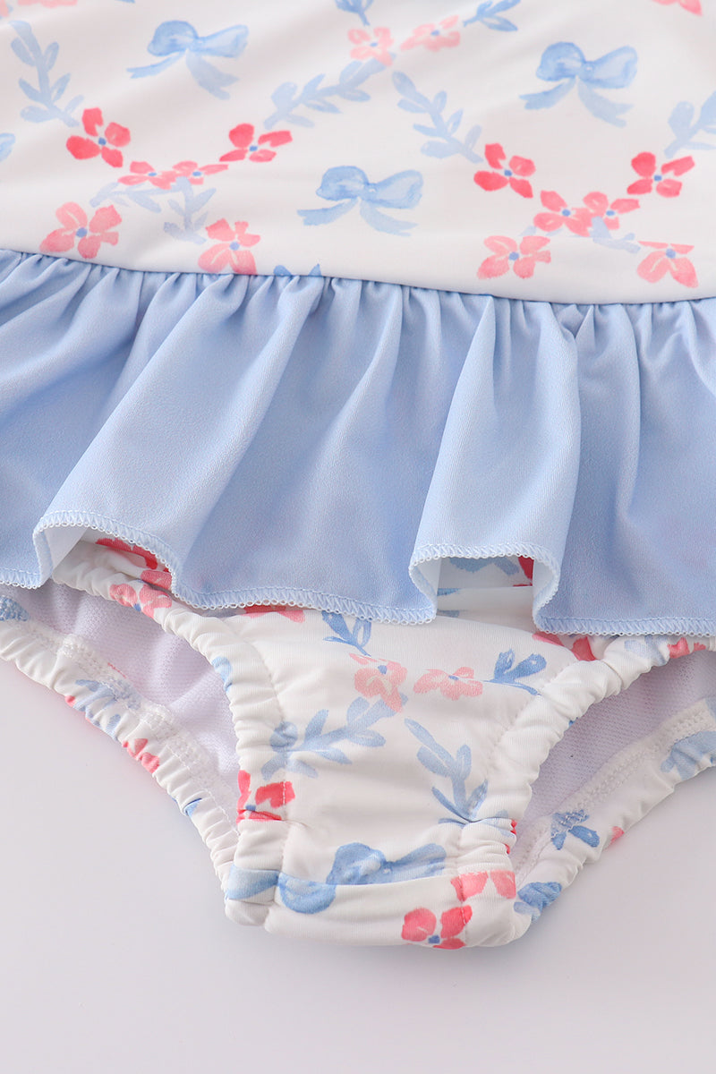 A charming blue lattice print swimsuit with a cute bow, perfect for summer fun.