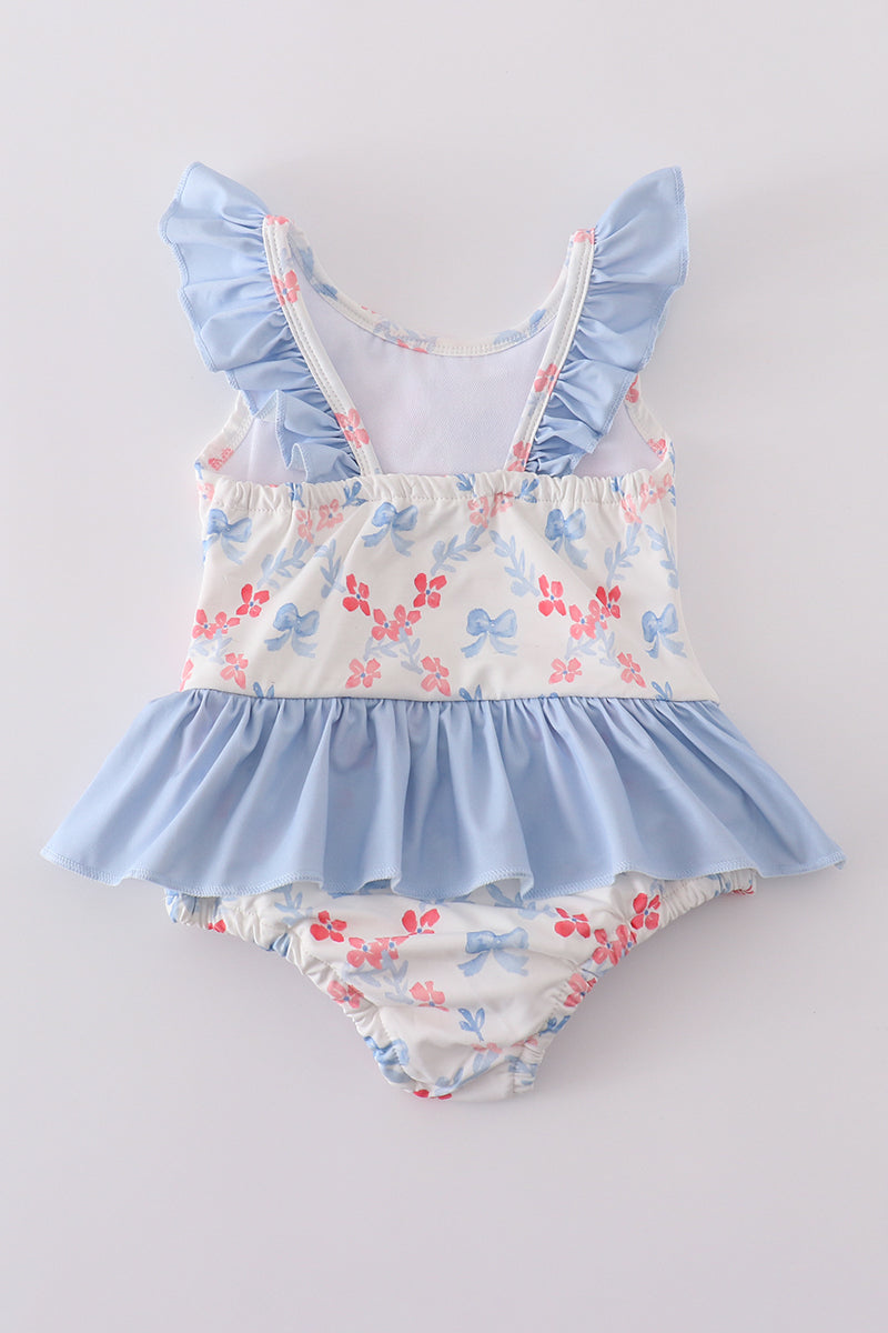 A charming blue lattice print swimsuit with a cute bow, perfect for summer fun.