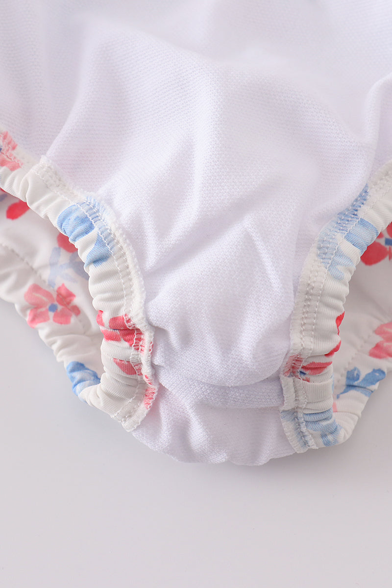 A charming blue lattice print swimsuit with a cute bow, perfect for summer fun.