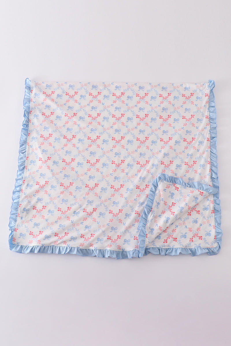 Cozy blue blanket with a charming lattice print and a sweet bow accent.