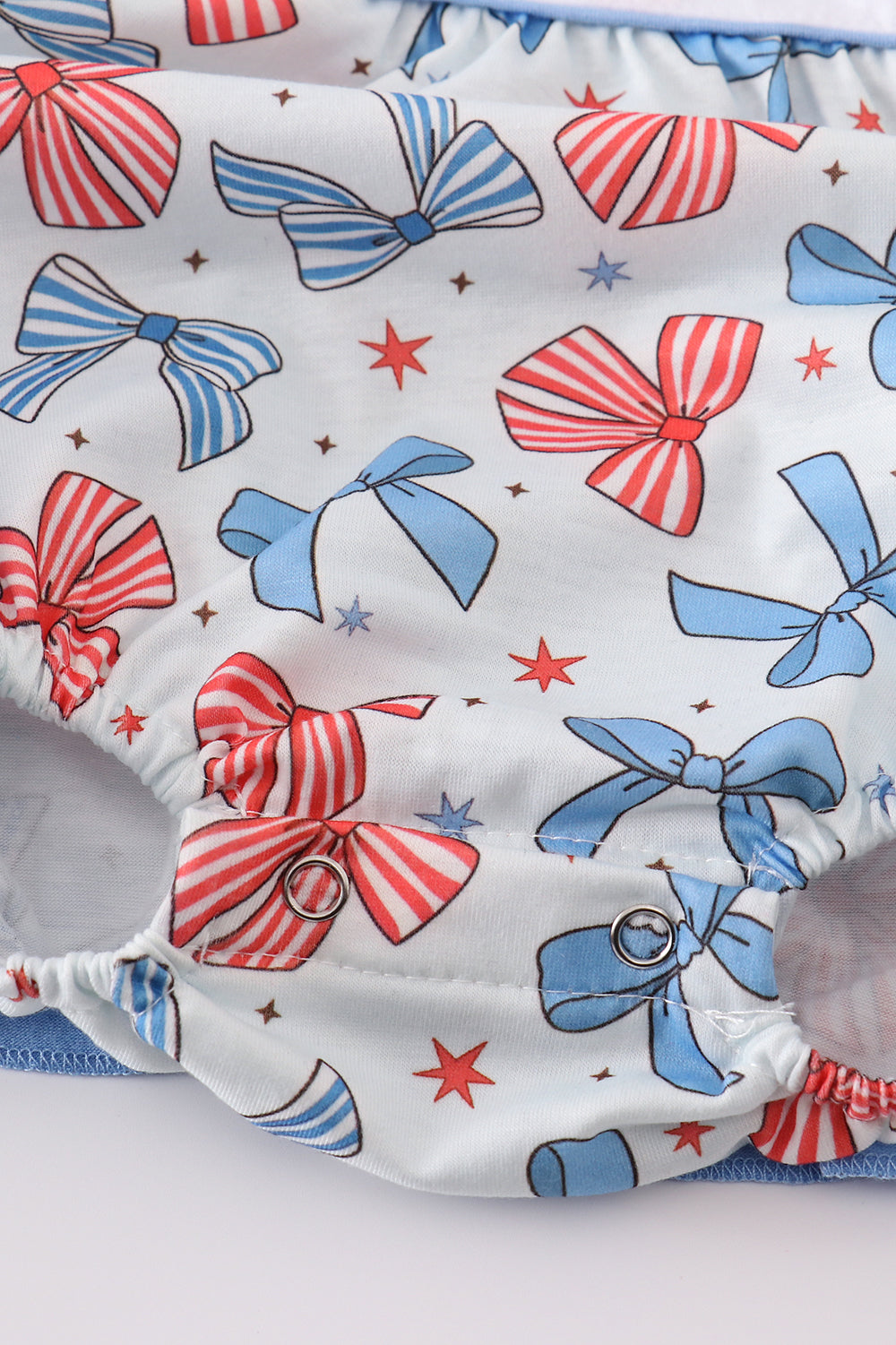 Adorable ruffle bubble with bow trellis print and delicate embroidery.