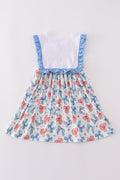 A sweet ruffle dress with bow trellis print and delicate embroidery, perfect for playdates.