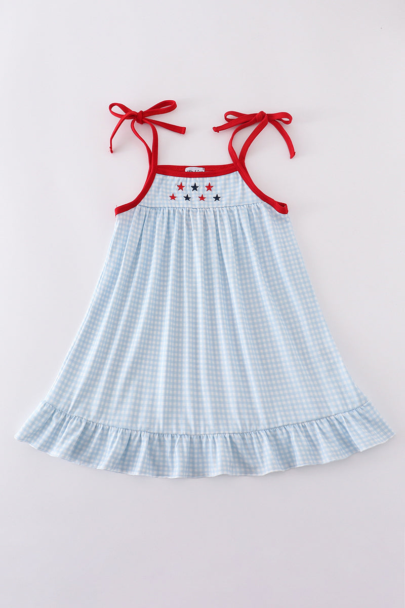 A charming gingham dress with star embroidery, perfect for playful adventures.