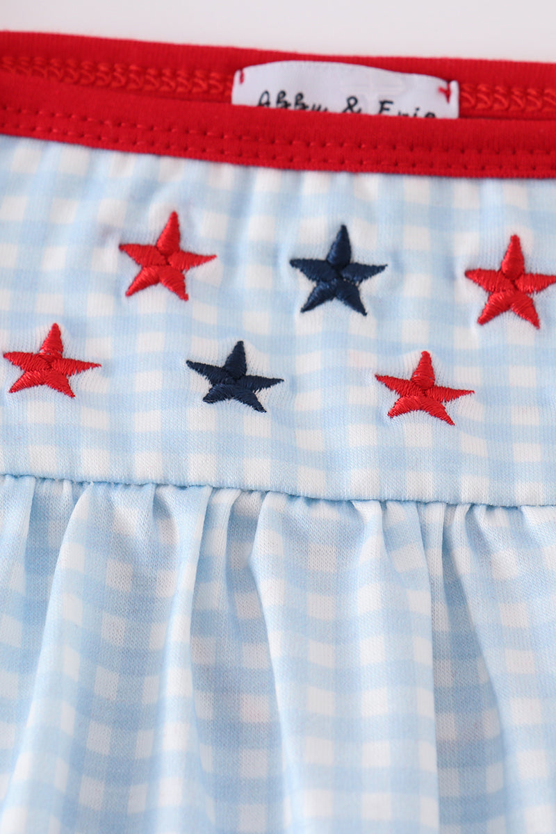 A charming gingham dress with star embroidery, perfect for playful adventures.