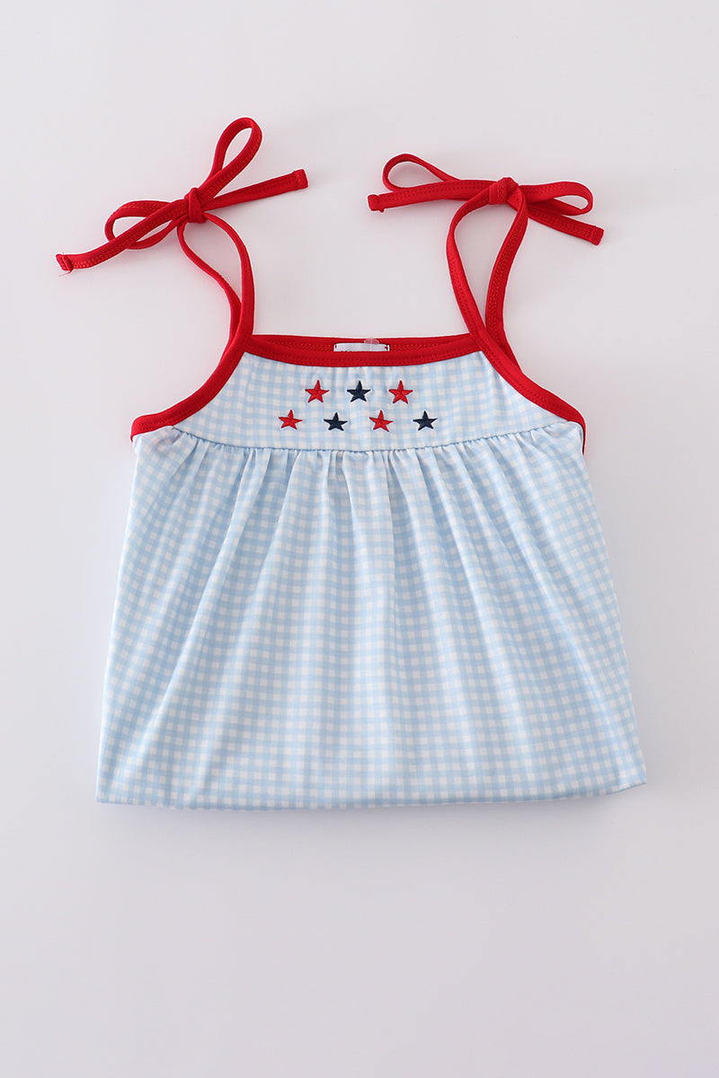 A charming gingham dress with star embroidery, perfect for playful adventures.