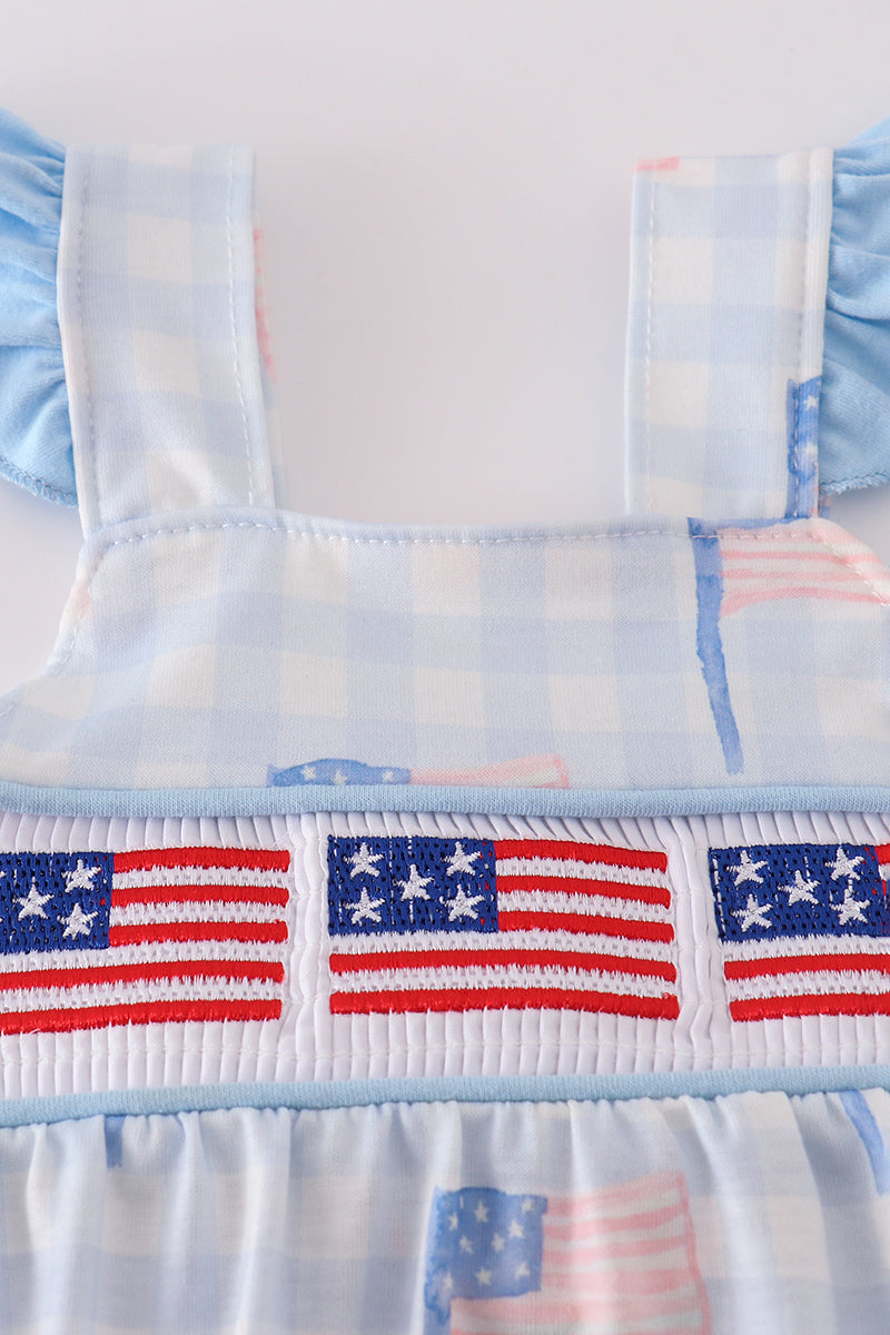 A charming gingham bubble romper with blue flag embroidery, perfect for summer.