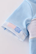 A charming blue bubble romper with delicate flag embroidery, perfect for summer fun.