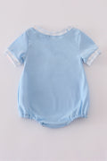 A charming blue bubble romper with delicate flag embroidery, perfect for summer fun.