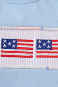 A charming blue bubble romper with delicate flag embroidery, perfect for summer fun.