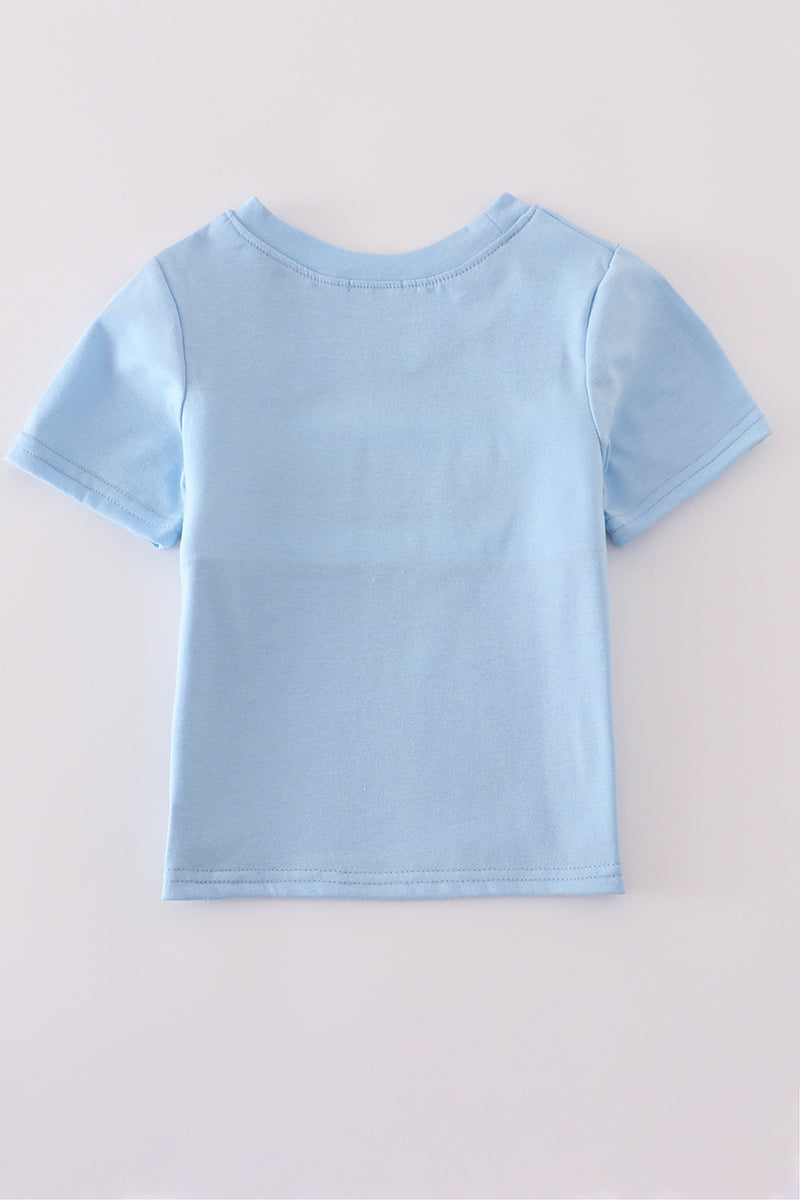 Blue flag embroidery top for kids, featuring playful flag patterns on soft fabric.