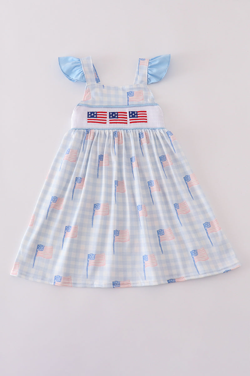 Blue gingham dress with smocked embroidery, perfect for summer outings.