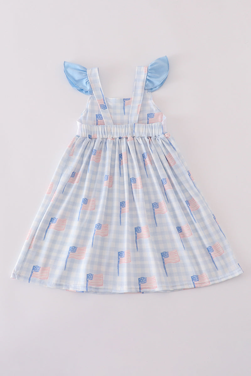 Blue gingham dress with smocked embroidery, perfect for summer outings.