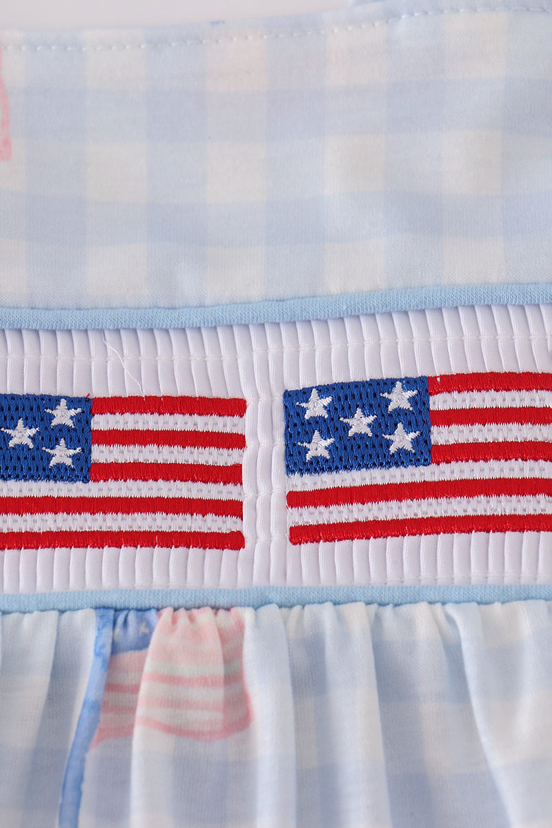 Blue gingham dress with smocked embroidery, perfect for summer outings.