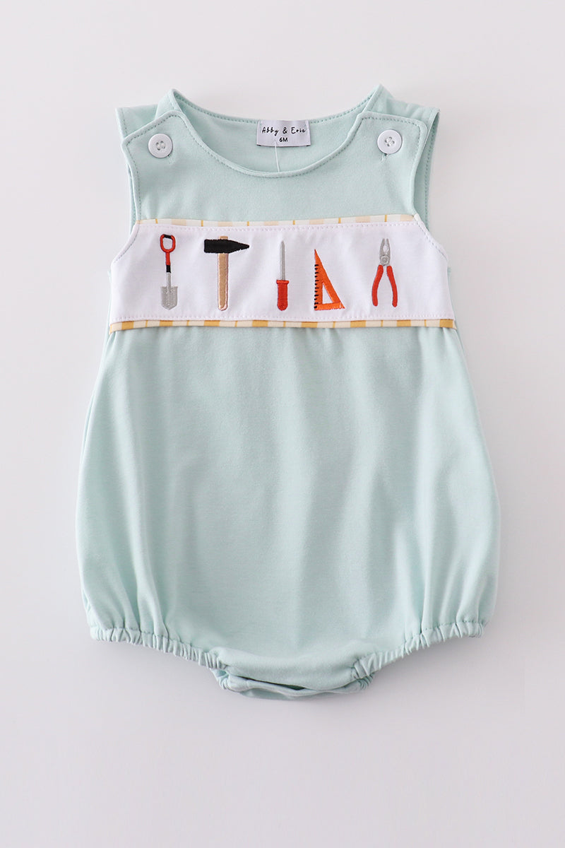 Adorable blue bubble romper with delicate tool embroidery, perfect for special occasions.