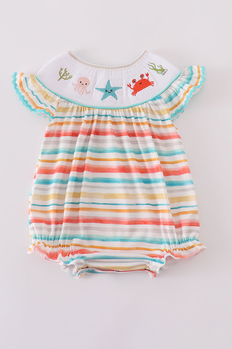 Colorful smocked bubble with rainbow stripes and marine creature embroidery.
