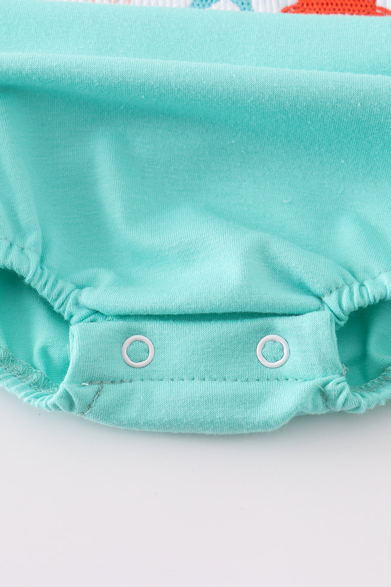 Adorable blue bubble romper with marine creature embroidery and smocked detailing.