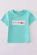 Children's blue smocked top with cute marine creature embroidery.
