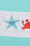 Children's blue smocked top with cute marine creature embroidery.