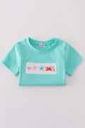 Children's blue smocked top with cute marine creature embroidery.