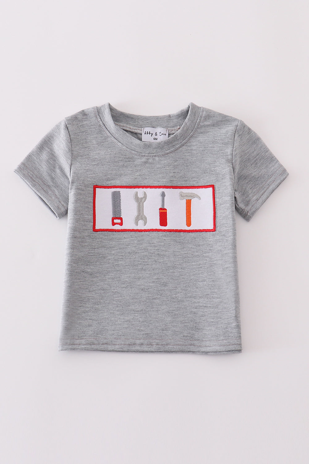 Grey tool embroidery top with playful patterns, perfect for everyday adventures.