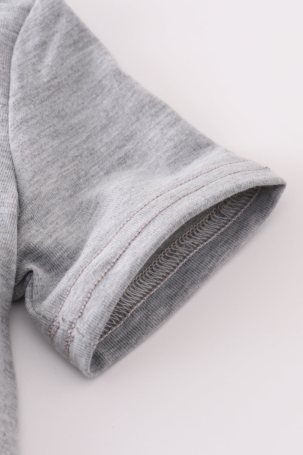 Grey tool embroidery top with playful patterns, perfect for everyday adventures.