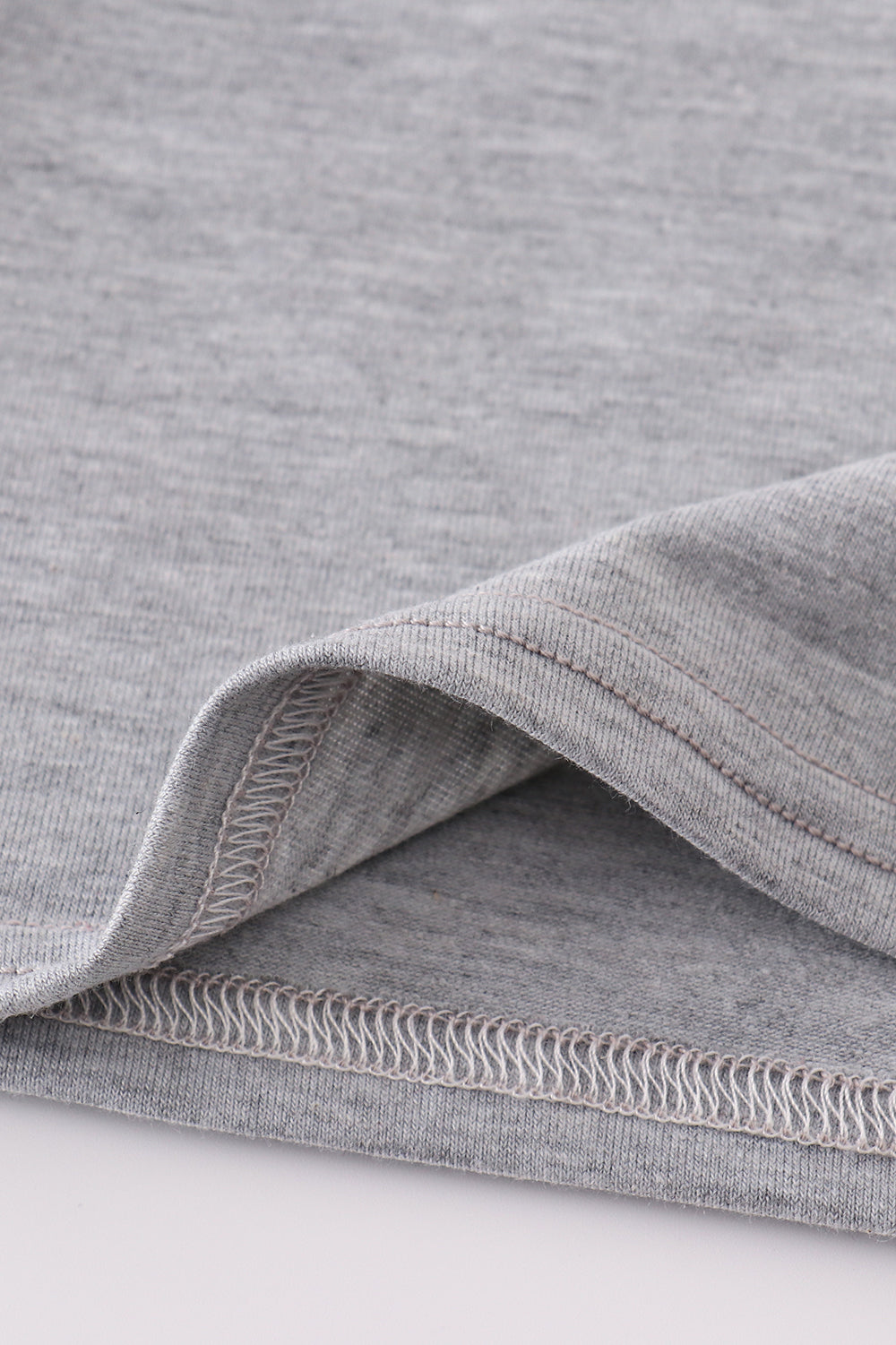 Grey tool embroidery top with playful patterns, perfect for everyday adventures.