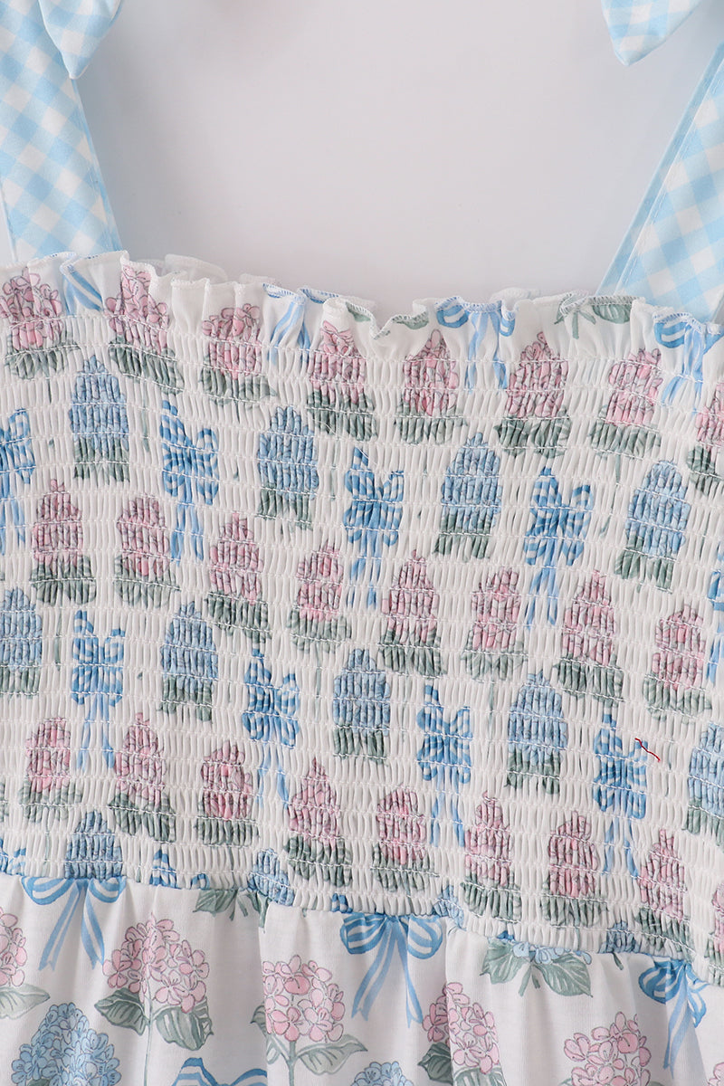 Matching blue hydrangea bow smocked dresses with delicate floral pattern for mom and child.
