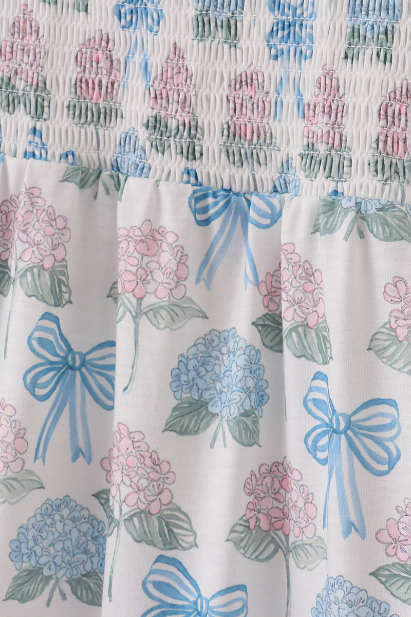 Matching blue hydrangea bow smocked dresses with delicate floral pattern for mom and child.