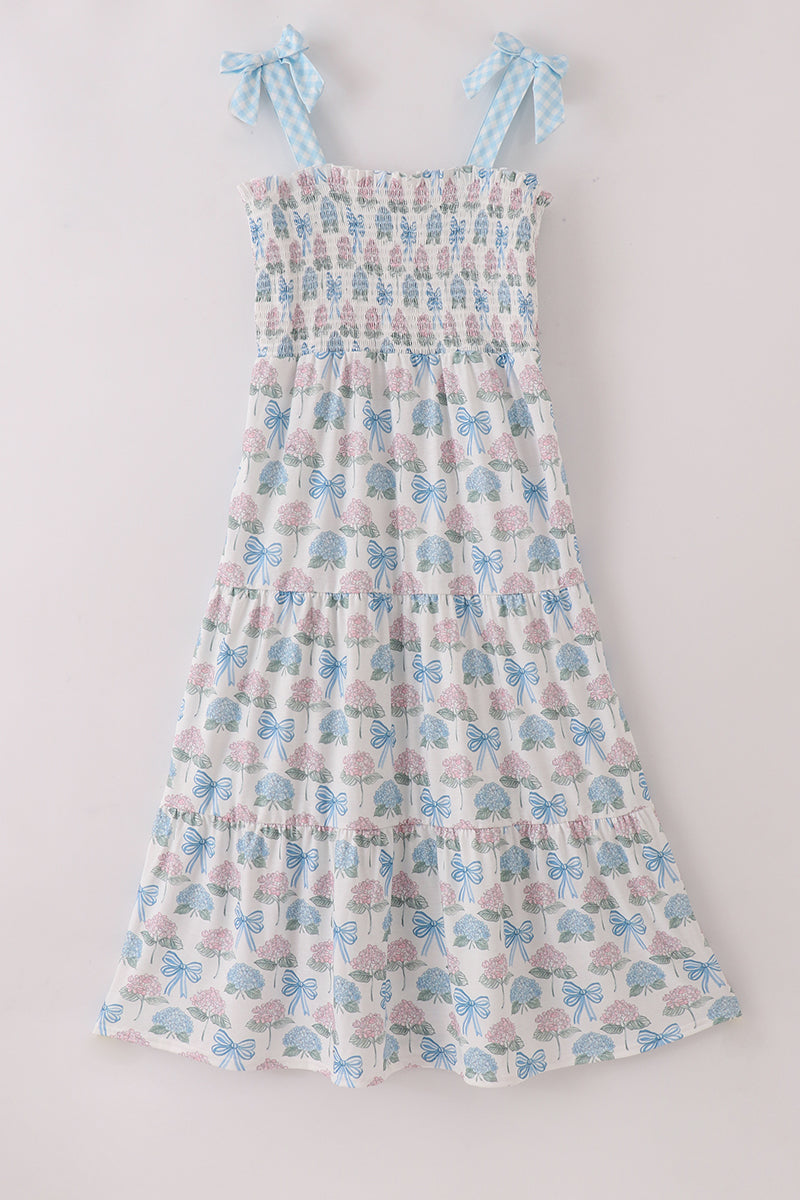 Matching blue hydrangea bow smocked dresses with delicate floral pattern for mom and child.