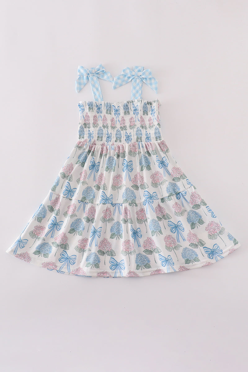 Matching blue hydrangea bow smocked dresses with delicate floral pattern for mom and child.