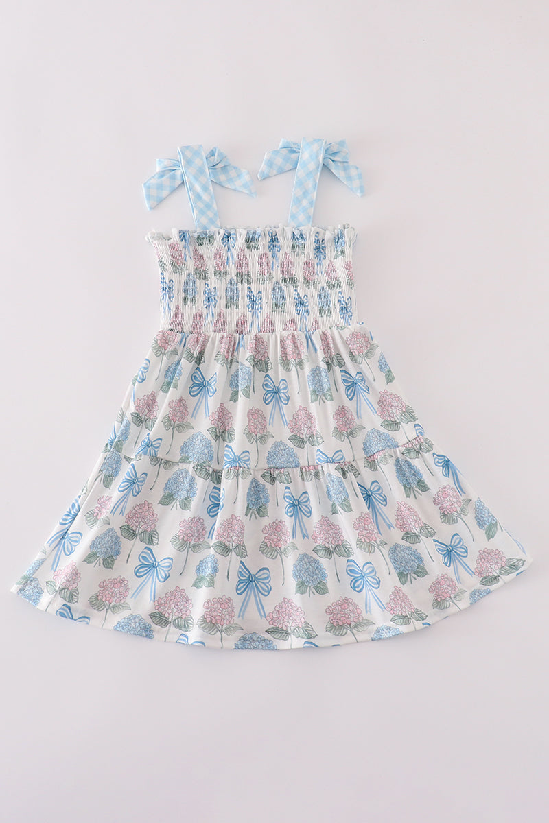 Matching blue hydrangea bow smocked dresses with delicate floral pattern for mom and child.