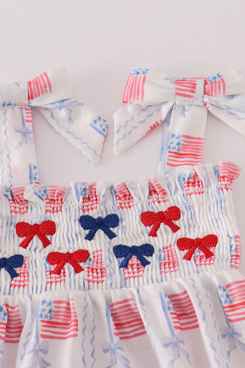 Adorable smocked bubble with bow embroidery, perfect for special occasions.