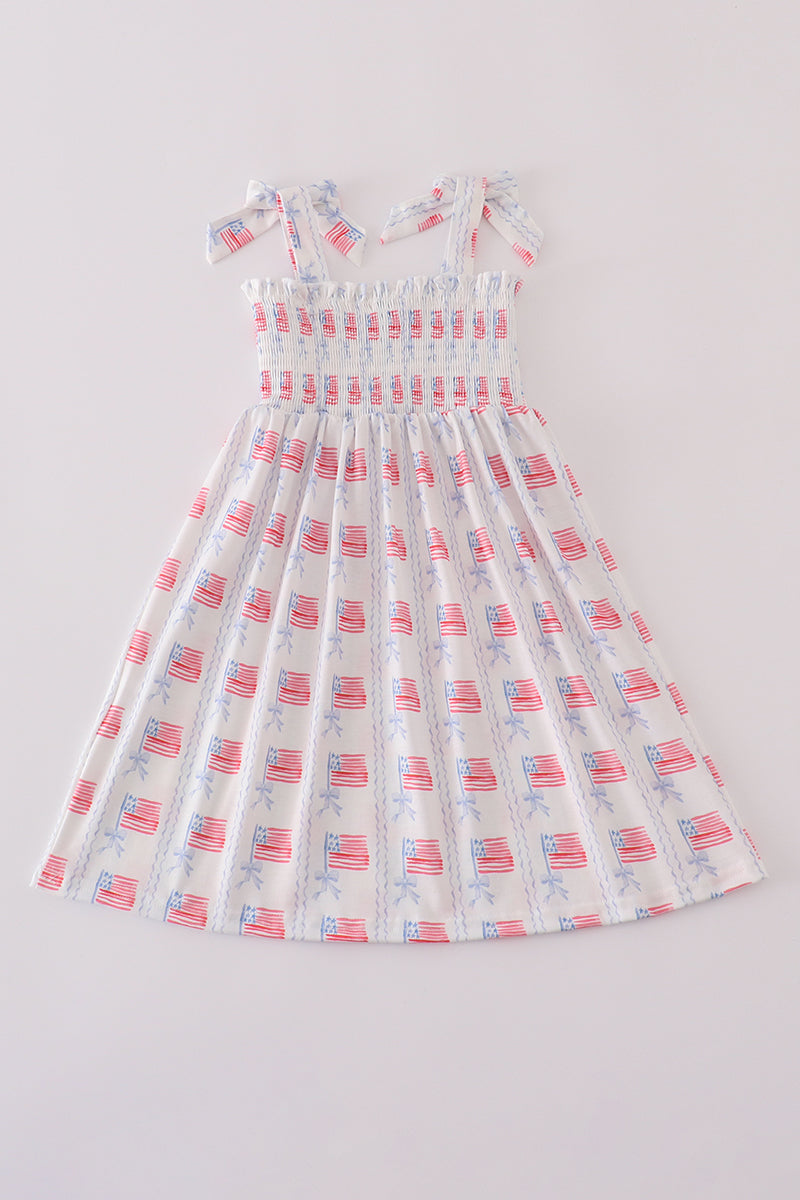 A charming pink smocked dress adorned with delicate bow embroidery, perfect for special occasions.