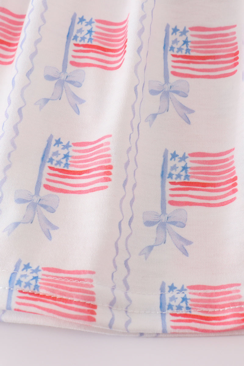 A charming pink smocked dress adorned with delicate bow embroidery, perfect for special occasions.