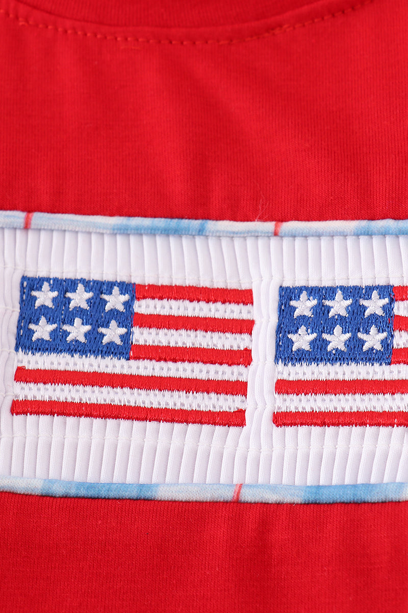 Children's smocked top with colorful flag embroidery, perfect for patriotic celebrations.