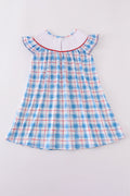 A charming smocked dress with colorful flag embroidery, perfect for festive occasions.