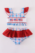 Two-piece swimsuit with flag embroidery, smocked plaid design, and UPF50+ protection.
