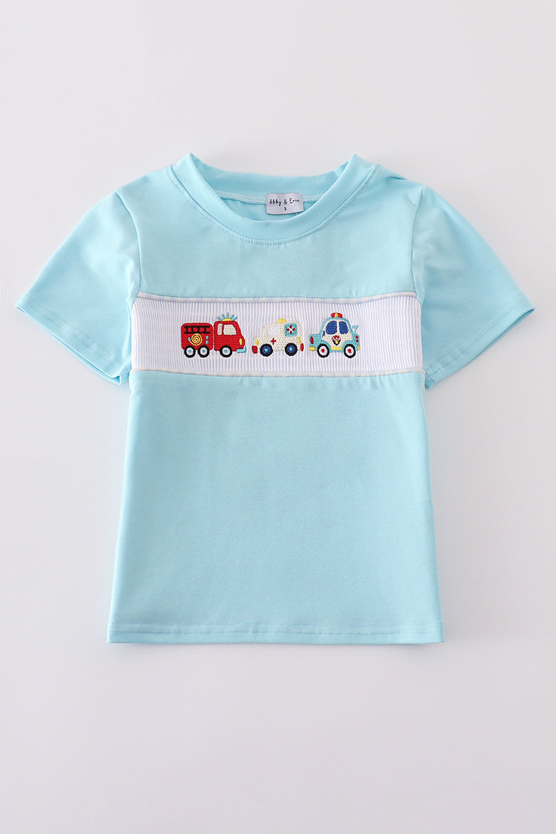 Blue smocked top with fire truck and police car embroidery for kids.
