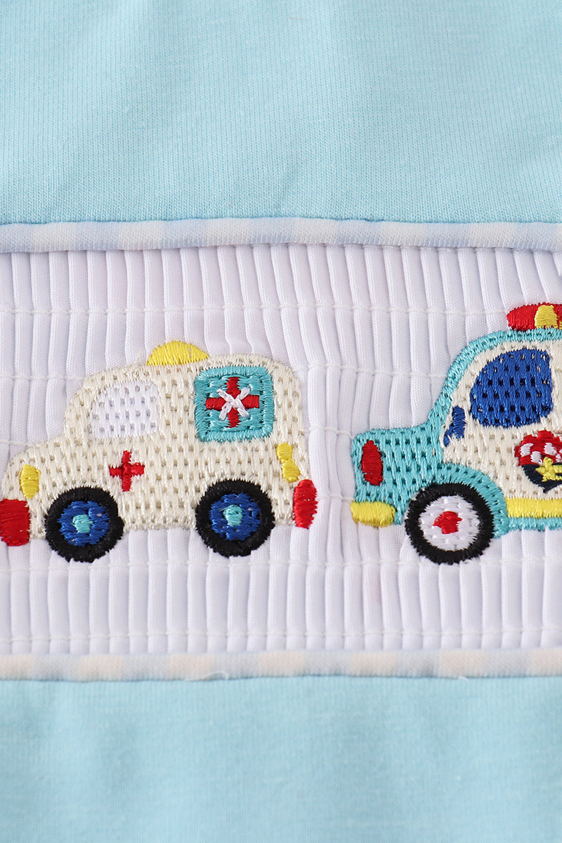 Blue smocked top with fire truck and police car embroidery for kids.