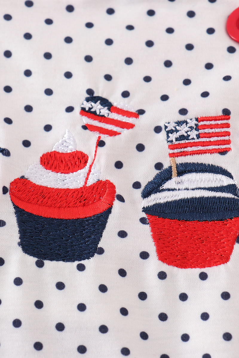 Adorable red ruffle bubble with cake embroidery and playful polka dots.