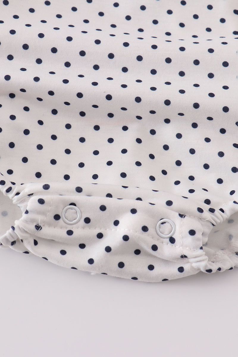 Adorable red ruffle bubble with cake embroidery and playful polka dots.