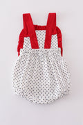 Adorable red ruffle bubble with cake embroidery and playful polka dots.