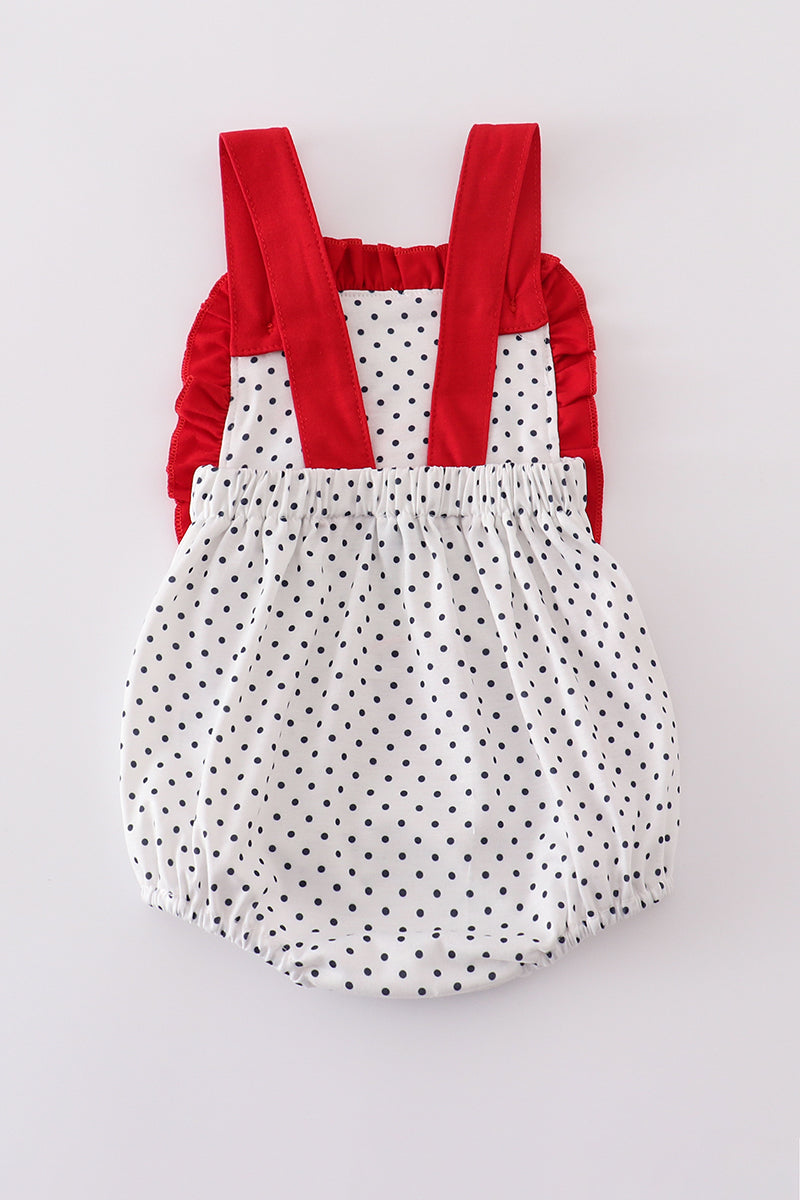 Adorable red ruffle bubble with cake embroidery and playful polka dots.